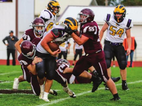Panther defenders AJ Lindskov (55) and Thane Keller (20) team up to stop Wolverine runner Brenden Begeman during their contest in Timber Lake on Sept. 3. Photo by Jon Flatland