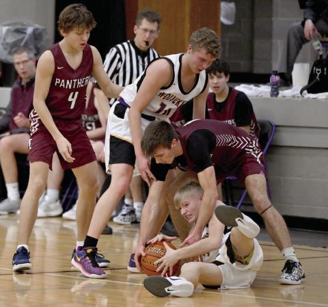 Timber Lake’s Gavin Farlee fights an unidentified Herreid-Selby player for control of a loose ball during the Panthers’ 58-29 win over the Wolverines last week. Looking on are Broc Bauer (4) and Herreid-Selby’s Jared Weisbeck (10). Photo by Marie DuPreez