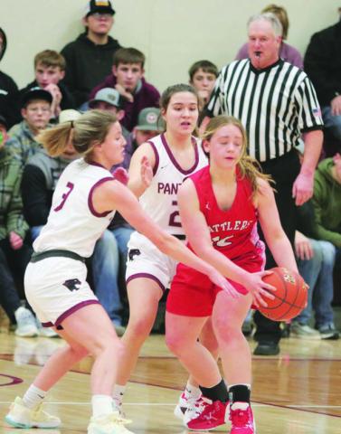 Lady Panther defenders Carlie Lawrence (3) and Abby Linderman utilize a half-court trap press to tie up Potter County’s Ashlee Kaup and ultimately force a turnover during first half action of Timber Lake’s win over the Battlers last week. Photo by Jon Flatland