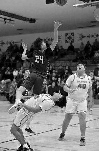 Timber Lake’s Kanton Hunt (24) drew a charging call after colliding with Cheyenne-EagleButte’s Danah Diver on a drive to the basket during inter-county boys basketball action in Eagle Butte last Tuesday, Feb. 18. Looking on for C-EB is Easton Lawrence (40) Photo by Marie DuPreez