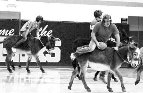 Players in the Donkey Basketball game sponsored by the Dupree Booster Club last Thursday, Jan. 23, had a hard time figuring out how to steer their donkeys ... and spent more time concentrating on staying on-board than they did scoring a basket. Above, Tee Birkeland, left, tries to get his donkey moving while Terry Russell (with basketball) wonders if he can stay on long enough to get a shot. Behind Russell is Kaden Deal. Photo by Patty Peacock