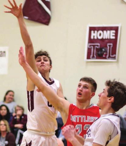 Panthers guard Kedrick Martin puts up a floater over Potter County’s Grant Luikens with TL’s Hunter Schrempp looking on. Photo by Jon Flatland
