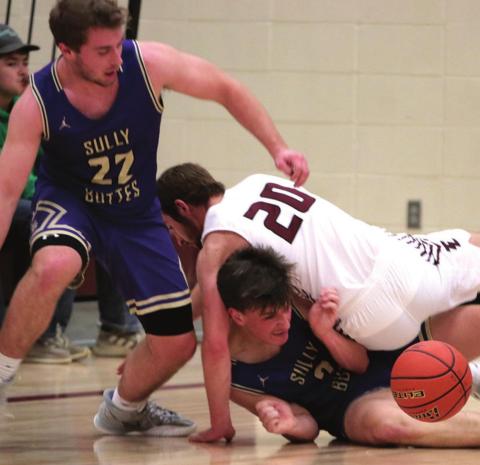 Timber Lake senior Brandt Ducheneaux (20) falls on Landon Hepker of Sully Buttes as they and the Chargers’ Jordan Schall (22) try and gather a loose basketball during their game this week. The physical play between the two successful programs has become customary in their non-conference regular season meetings.