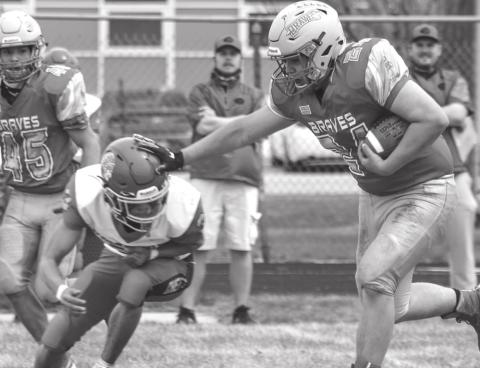Cheyenne-Eagle Butte senior running back Antonio Lasley stiff arms an Omaha Nation defender during All Nations Football League action in Eagle Butte on Friday, April 30. The 1-3 Braves will travel to McLaughlin this Friday, May 7, to take on the 0-2 Mustangs. Photo by Jon Flatland