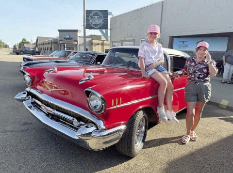Marie Gross and her daughter, Sophia, were at the Rods n’ Reels event at The Corner Bar &amp; Grill on Saturday, June 21, showing off their ride - beautiful 1957 Chevrolet with red and black interior. The vehicle is owned by their husband and father Richard Gross, who is one of the organizers of the event. Photos by Kathy Nelson