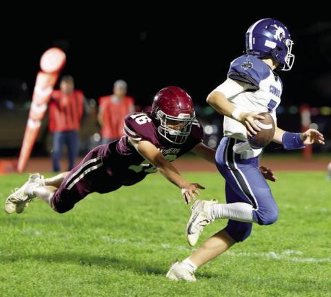 Sophomore Cooper Keller (16) makes a diving tackle on Lemmon-McIntosh quarterback Max Anderson during Timber Lake’s 46-28 Homecoming win over the Cowboys. The Panthers, 2-4 on the season, square off against 0-6 Gettysburg this Friday, Oct. 10. Photo by Marie DuPreez