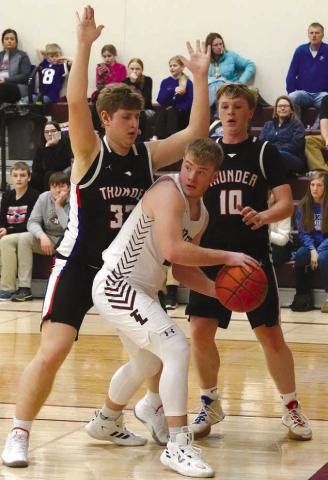 Junior forward Treyton DuPreez looks for a teammate to pass to after getting trapped on the baseline during Timber Lake’s win over North Central last Thursday.