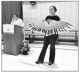 Kaycee Cronin displays a wall hanging created by Mitch Zeug from old piano keys that was auctioned off at the Prairie Parish Fall Festival held Sunday, Nov. 3, at the Isabel Community Center. Cronin is the new director of the Klein Ranch. Lois Bartlett, left, recorded the bids. Photos by Kathy Nelson