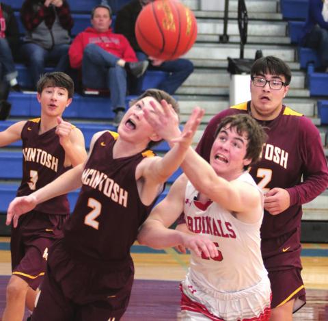 McIntosh’s Christian Campbell (2) and Bison’s Logan Reiff (25) during their conference tournament matchup. Watching are Tigers Wyatt Schell (3) and Daniel Demery (42). Photo by Jon Flatland