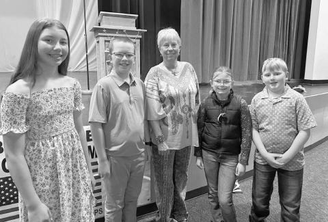 Johny Weber (middle) was the guest speaker at Timber Lake’s Memorial Day program on May 26. Students who read their Americanism essays and poems were (l-r): Brinley Mowrer, Garrett Nilson, Stella Nilson, and Isaac Schweitzer.