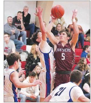 Panther guard Gavin Farlee (5) puts a jump shot up past the attempted block of a North Central defender during boys hoops action in Eureka last Thursday, Dec. 29. Farlee finished with six points in Timber Lake’s 57-54 overtime win. Photo by Jon Flatland