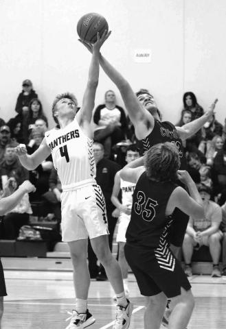 Timber Lake’s Gracen Hansen and Lemmon’s Jacob Sonsalla battle for a rebound during the Panther boys season home opener last Friday, Dec. 9. Hansen finished with six points and three rebounds in a 63-46 victory. Photo by Jon Flatland