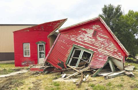 LEFT: Part of the former Dewey County Jail building at the corner of 9th and E streets in Timber Lake, now owned by John Linderman, is being demolished.