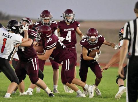 Rance Gross (5) shoots for a gap in the line during Timber Lake’s football season opener against Ipswich last Friday, Aug. 22. Creating a hole for the sophomore running back are Mason Bickel (54) and Xander Keller (58) while Broc Bauer (4) looks on. Gross finished with 11 yards on the night as the Tiger defense kept the Panthers in check. Photo by Marie Du Preez