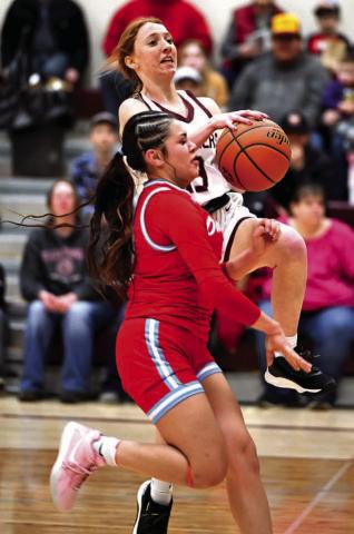 Sophomore guard Sara Keller is fouled by a Cheyenne-Eagle Butte defender as she drives for a layup during recent girls basketball action in Timber Lake. The Lady Panthers advanced out of the first round of the Region 8B Tournament last week but were eliminated in the second round by undefeated and third-ranked Harding County Photo by Marie Du Preez