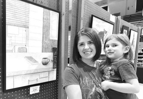 Ali Eigelaar and her daughter Thea with Ali’s blue ribbon drawing at the Mobridge Art Show.