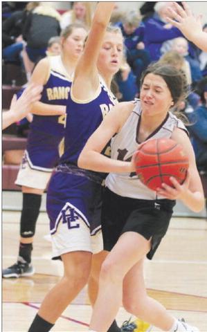 Timber Lake’s Jaylee Schoelerman takes a body check from a Harding County defender while driving the lane during the 2022 LMC Middle School Girls Basketball Tournament on Saturday, Dec. 3. Timber Lake finished third and Harding County was runner-up to Lemmon. Photo by Jon Flatland