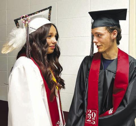 Seniors Kessa Bigger (left) and Matthew Bowlby await their cue to enter the gym at the Timber Lake High School graduation ceremony on May 10.