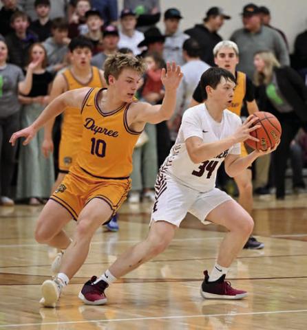 ABOVE: Rance Martin (34) steals the ball from Brayden Terveen-Smith during Timber Lake’s matchup against Dupree last Tuesday. Timber Lake overcame a 16 point first quarter deficit to pull out an exciting 54-52 victory over the Tigers.