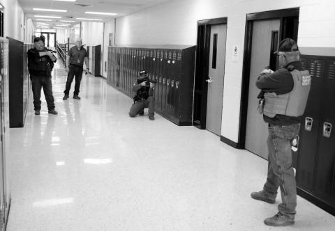 The Dupree School held an active shooter drill last week which involved evacuating staff and students from the building while law enforcement searched for and apprehended a lone gunman. Focused on a room where the shooter barricaded himself are l-r Ziebach County Deputy Mike Denavi; Dupree School Dean of Students/Truancy/Emergency Manager Shannon Hinrichs, CRST Police Officer Jeremy Reede and Ziebach County Sheriff Gary Cudmore. Photo by Jon Flatland