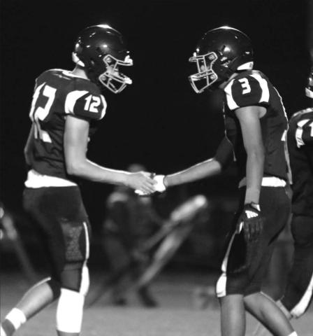 Seniors Kedrick Martin (12) and Chazz Gabe (3) celebrate another touchdown. Martin has thrown to Gabe for four TDs in the last two games.