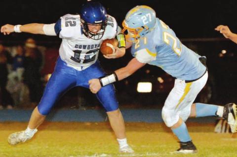 Lemmon/McIntosh senior QB Cody Thompson is pressured by Hamlin’s Michael Stevenson during their state semifinal round game. Photo by Roger Merriam, Watertown Public Opinion