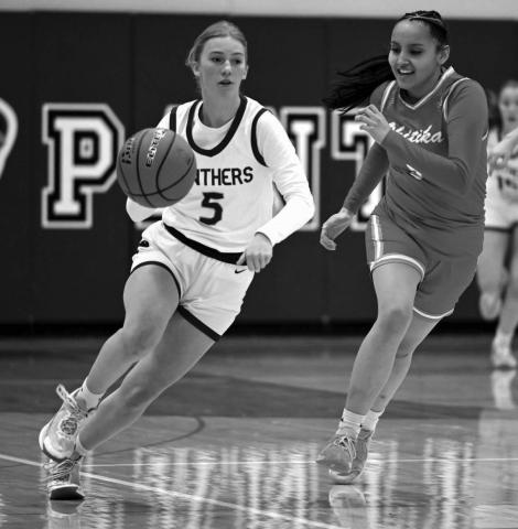 Panther senior Averie Marshall pushes the ball up-court during recent action against an unidentified Cheyenne-Eagle Butte defender during recent action. The Lady Panthers won the battle for bragging rights in Dewey County 52-37. Photo by Marie Du Preez