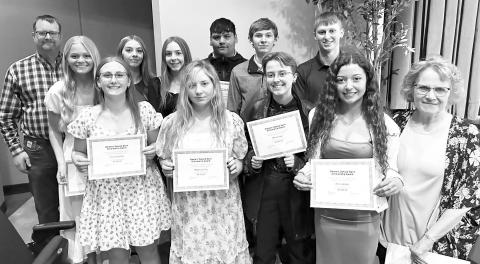 Western Dakota Bank awarded $1000 scholarships to 12 students. The 10 from Timber Lake are pictured with Rusty Gebhardt (back, left) and Karma Nash (front, right) of Western Dakota Bank. They are (Front (l-r) Emma Johnston, Maddie Lou Gray, Maria Scherer, Arianna Bieber; Back: Hailey Roggow, Gailup Bollinger, Geana Bollinger, Hayden Thompson, Gavin White, and Holden Gill. The other two recipients are Fallon Peterson of Faith and Katelyn Gebhart of Lemmon.