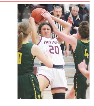 Sophomore forward Jasmine Nash (20) is fouled while pulling down a rebound during action against Aberdeen Roncalli last Friday, Jan. 27. The visiting Crusaders upset the No. 4 ranked Lady Panthers 62-49. Photo by Jon Flatland