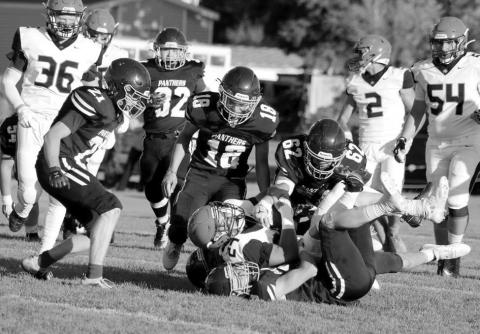 Timber Lake linebacker Cole Ducheneaux (on the bottom of the pile) gets an assist in tackling a Philip runner from Treyton Du Preez (62) as Brody Ellison (18) and Eddie Keller (21) move in and Gabe Keller (32) trails the play. The Panthers will attempt to break out of two-game losing streak when they host North Central on Friday, Sept. 6, in a 6 pm kickoff at Kraft Field. Photo by Jon Flatland