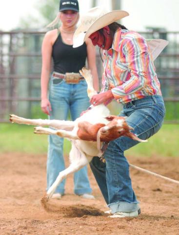 Charly Etzkorn of Dupree flips a goat during the goat-tying event at the annual Ziebach County 4-H Rodeo in Dupree on Saturday, July 15. More than 150 contestants took part in the two day event held under hazy conditions caused by smoke from Canadian forest fires. Photo by Jon Flatland