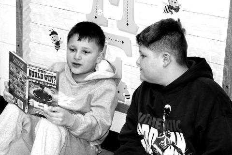 Ryatt Wright (3rd grader) reading to Jett Keckler (6th grader)