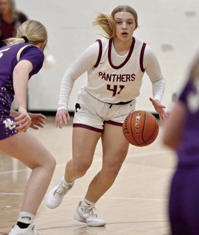 Eighth grader Madalyn Hermes looks for an opening in the Harding County defense to drive the lane during Timber Lake's battle with the Ranchers last week. The Lady Panthers were upon the Ranchers early, but unbeaten and state-ranked Harding County battled back for the win.