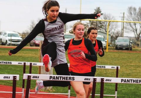 Abby Linderman leaps over a hurdle