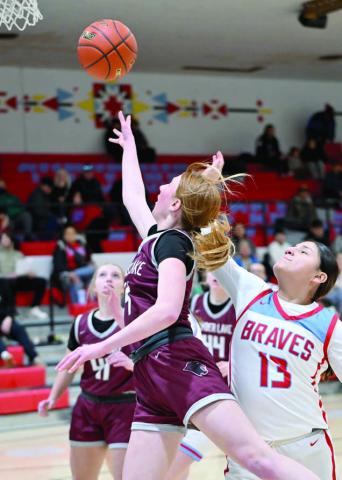 Junior Sara Keller lays a shot up while being defended by Koree Buffalo Halfrib of Cheyenne-Eagle Butte during the Lady Panthers’ loss to the Braves last week (see Page 9). Timber Lake took on Faith in the first round of the Region 8B Tournament on Tuesday evening as this issue of the Topic was going to press. Photo by Marie DuPreez