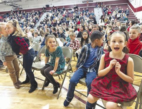 ANTICIPATION Kindergartners wait for their turn on stage at the Timber Lake Elementary Christmas Concert on December 4. Becket Rose (left) whispers to Lyllian Tesch while Harper O’Leary, Pieter Scholtz and Rylie Traversie make eye contact with the camera.