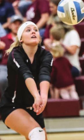 Bailey Keller fields a serve in recent varsity volleyball action.