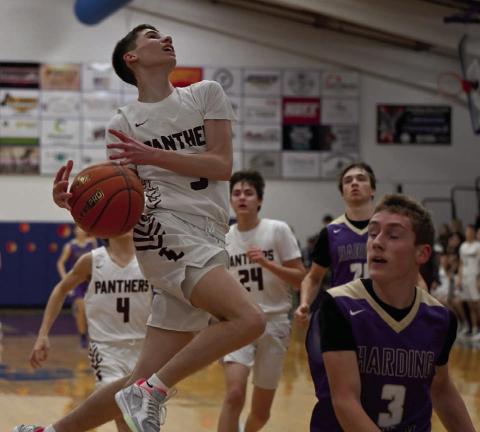 Panther guard Braden Lawrence loses his grip on the basketball while driving to the hoop on a layup attempt during Timber Lake’s win over Harding County in the LMC Tournament. Defending on the play is Shawn Glines of Harding County. Photo by Marie DuPreez