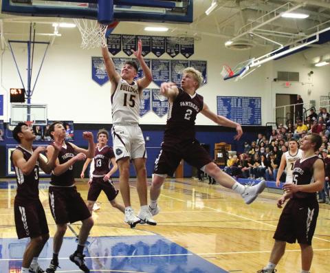 Timber Lake players (L-R) Chazz Gabe, Trenton Hansen, Hunter Schrempp, Brady Sandquist and Hank Kraft watch as De Smet’s Kalen Garry (15) drives to the basket. Photo courtesy of Mike Siefker, Kingsbury Journal