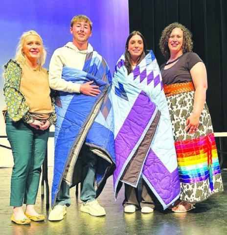 Cole Ducheneaux and Mckenzi Vomacka (middle) received star quilts and $2000 scholarships in memory of Jim O’Leary at the TLHS Awards Day. Making the presentation were Jim’s sister, Laura O’Leary Rose (left), and his widow, Megan Simon O’Leary (right). The award honors a student who demonstrates the character traits of the late Jim O’Leary. There were ten applicants for the two scholarships awarded.