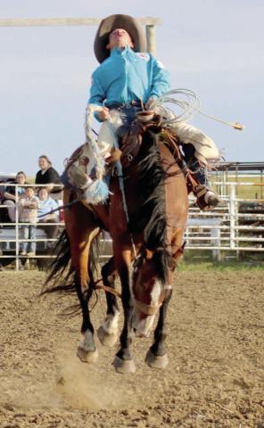 Ride him cowboy ... Owen Garreaux of Eagle Butte shows off the form that won him first place in the Hometown Days Ranch Bronc Riding event held last Thursday, July 17, at the Eagle Butte Rodeo Arena. Photo by Jon Flatland