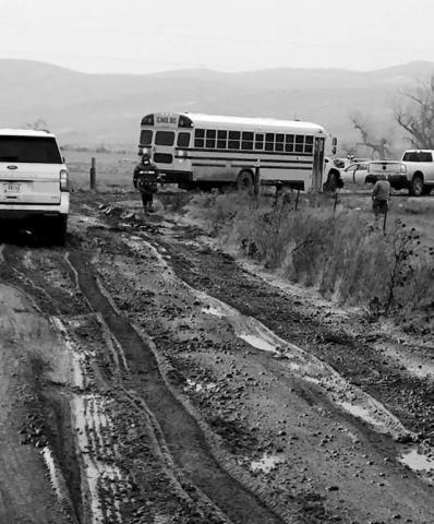 Volunteers had to be called in to push out a Takini School bus that became stuck on one of the nearly impassable roads in the Cottonwood area on Tuesday, Nov. 25. No students were on the bus at the time it became stuck. Schools across the area cancelled classes and activities on Tuesday due to dangerous travel conditions.