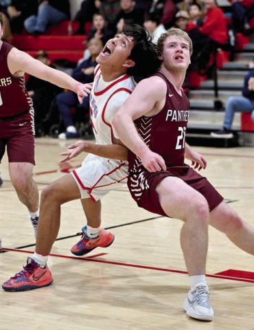 Timber Lake seniorTreyton DuPreez (right) and C-EB’s Jayden Marshall (left) battle for rebounding position during the Panthers’ loss to the Class A Braves last Tuesday, Feb. 18. See more Timber Lake boys basketball coverage on Page 10. Photo by Marie DuPreez