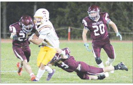Timber Lake’s Caleb Bieber (25) and Holden Gill (3) combine to take down a Stanley County runner while Thane Keller (20) moves in to assist during the Panthers overtime win over the Buffaloes last Friday, Sept. 30. Photo by Jon Flatland