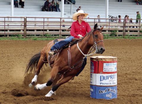 Jazmyn Longbrake of Dupree leans in as her horse makes the final turn during barrel racing action Saturday, July 19, at the 4-H regional rodeo in Dupree. No results were posted by the time this issue of the Topic went to press. Photo by Jon Flatland