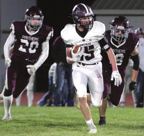 Timber Lake defenders Thane Keller (20) and Jayce Lawrence (19) chase a Platte-Geddes ball carrier during their state semifinal football game in Timber Lake. Photos by Jon Flatland