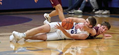 Timber Lake guard Cole Ducheneaux battles Lemmon’s Blair Ham (in white) for a loose ball during the boys basketball season opener between the two teams last Friday, Dec. 13, in Lemmon. Ham would later hit a game-winning 3-pointer with eight seconds remaining to give Lemmon a 64-62 win. Topic photo by Marie DuPreez