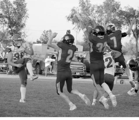 Braydon Terveen-Smith (32) blocks a Potter County punt during the Dupree Tigers win over the Battlers last Friday, Sept. 13. Rushing the punter with him were Cruz Birkeland (2) and Fletcher Birkeland (7). Cruz Birkeland ended up scooping up the blocked kick and tumbling into the end zone for a touchdown. Photo by Jon Flatland