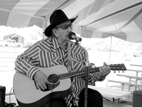 Warming up the audience prior to the Days of 1910 Talent Show under the big tent on Main Street last Thursday, July 24, was White Horse balladeer Frankie Thompson, a favorite among local residents. Thompson sang from his set list and also took requests from the audience. Photo by Jon Flatland