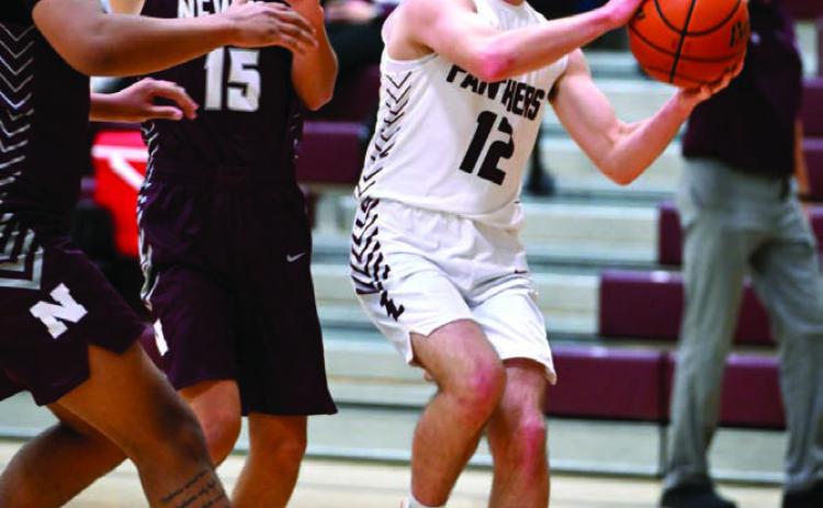 Junior guard Cole Ducheneaux drives to the hoop during the Panthers 83-19 win over Newell last week. Duchenaux finished the contest with eight points. Photo by Marie Du Preez